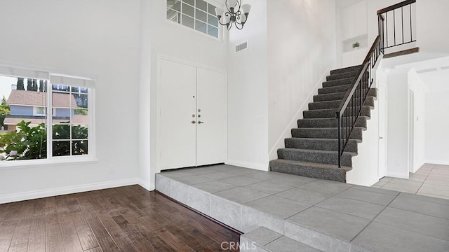 25866 Greenhill, Lake Forest, CA 92630 - foyer with stairway, a high ceiling, wood finished floors, and a chandelier