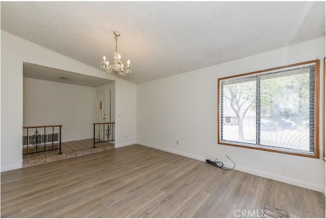 6318 Westview Dr, Riverside, CA 92506 - empty room featuring light wood finished floors, a chandelier, and a textured ceiling