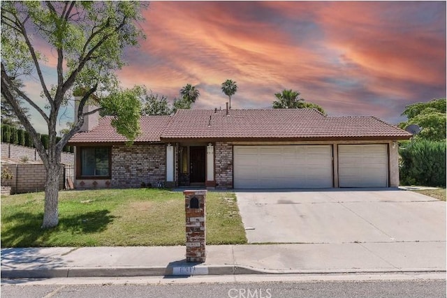 6318 Westview Dr, Riverside, CA 92506 - ranch-style house featuring a tile roof, a garage, driveway, and a lawn