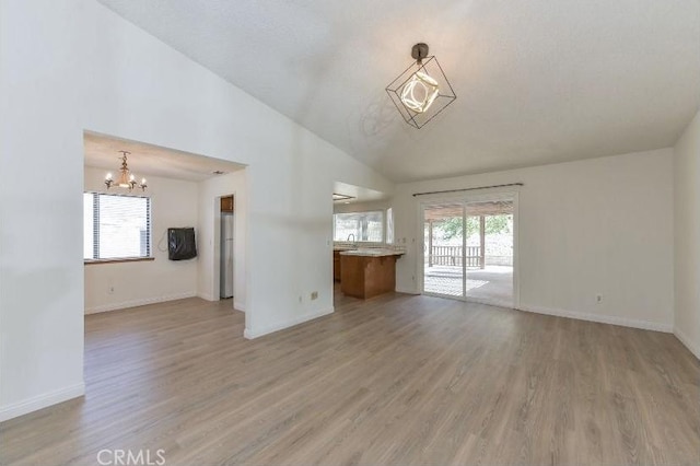 6318 Westview Dr, Riverside, CA 92506 - unfurnished living room with a chandelier, light wood-type flooring, and high vaulted ceiling