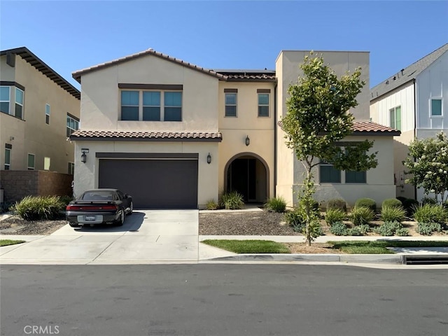 2617 E Tatum Ln, Ontario, CA 91762 - view of front facade featuring concrete driveway, a tiled roof, an attached garage, solar panels, and stucco siding