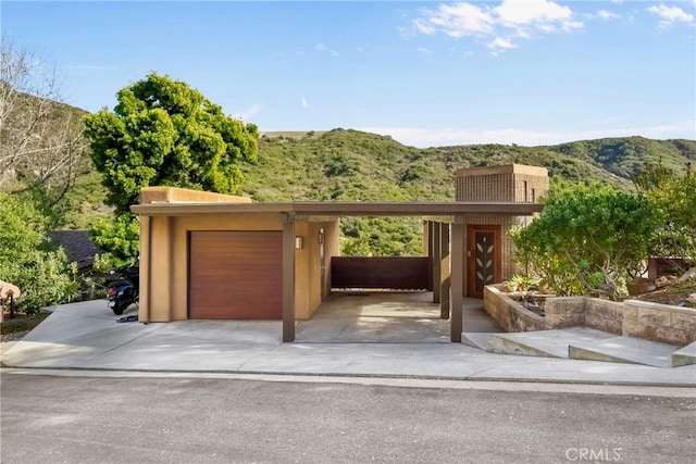 1372 Morningside Dr, Laguna Beach, CA 92651 - view of front facade featuring a mountain view, a garage, stucco siding, and a chimney