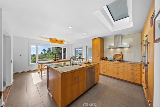 1372 Morningside Dr, Laguna Beach, CA 92651 - kitchen featuring stainless steel appliances, wall chimney exhaust hood, a skylight, a center island with sink, and recessed lighting
