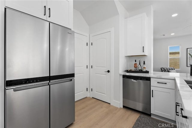14941 Almond Grove Ct, Tustin, CA 92780 - kitchen featuring stainless steel appliances, light wood-type flooring, white cabinets, recessed lighting, and light stone counters