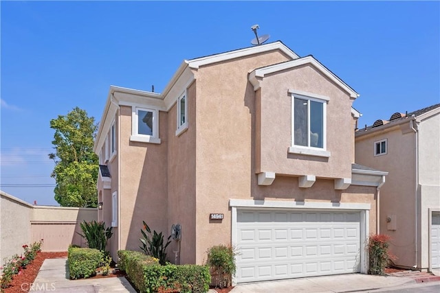 14941 Almond Grove Ct, Tustin, CA 92780 - back of property featuring stucco siding, an attached garage, and concrete driveway