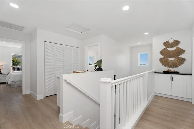 14941 Almond Grove Ct, Tustin, CA 92780 - hall featuring an upstairs landing, attic access, light wood-style flooring, plenty of natural light, and recessed lighting