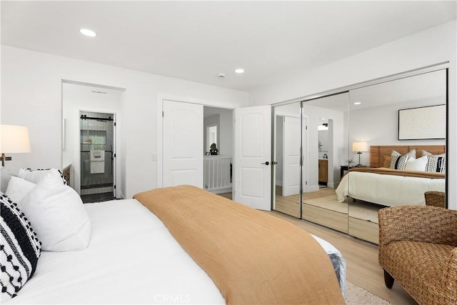 14941 Almond Grove Ct, Tustin, CA 92780 - bedroom featuring light wood-style floors, recessed lighting, connected bathroom, and a closet