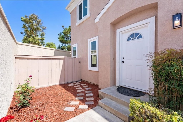 14941 Almond Grove Ct, Tustin, CA 92780 - doorway to property with stucco siding