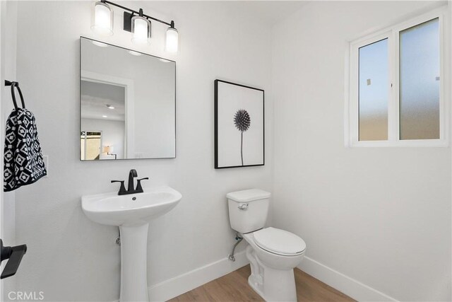 14941 Almond Grove Ct, Tustin, CA 92780 - half bathroom featuring baseboards and wood finished floors