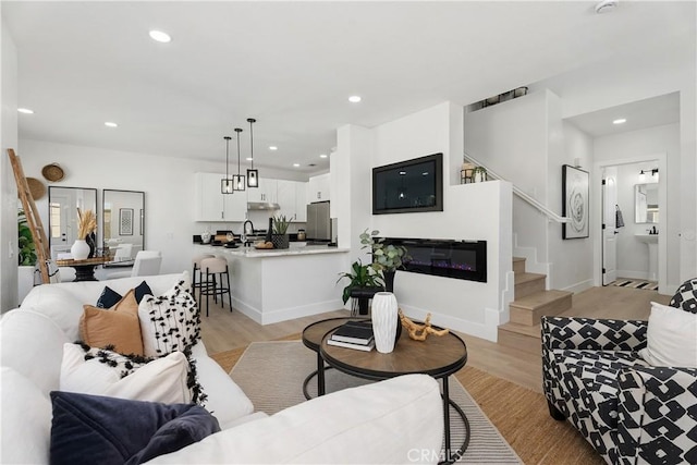 14941 Almond Grove Ct, Tustin, CA 92780 - living area with light wood-type flooring, stairway, and recessed lighting