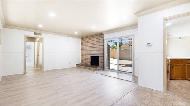 5449 E Fairbrook St, Long Beach, CA 90815 - unfurnished living room with crown molding, a fireplace, light wood-style floors, and recessed lighting