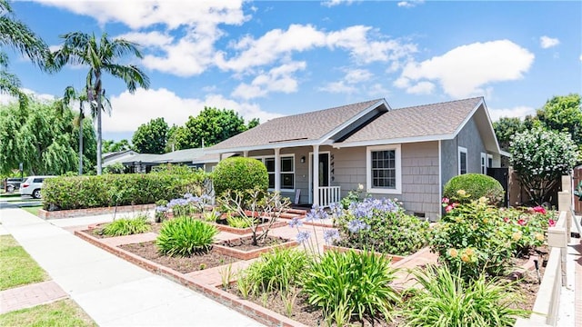 5449 E Fairbrook St, Long Beach, CA 90815 - ranch-style home featuring a garden and a shingled roof