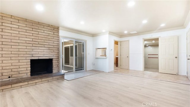 5449 E Fairbrook St, Long Beach, CA 90815 - unfurnished living room featuring crown molding, light wood-style flooring, a brick fireplace, and recessed lighting