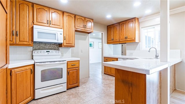 5449 E Fairbrook St, Long Beach, CA 90815 - kitchen featuring white appliances, a peninsula, recessed lighting, decorative backsplash, and brown cabinets