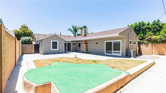 5449 E Fairbrook St, Long Beach, CA 90815 - rear view of house with a fenced backyard, stucco siding, a chimney, and a patio