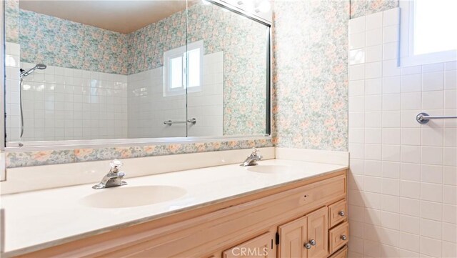 5449 E Fairbrook St, Long Beach, CA 90815 - full bathroom featuring wallpapered walls, double vanity, and tiled shower