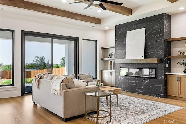 5891 Crestmoor Dr, Paradise, CA 95969 - living area with ceiling fan, a fireplace, beamed ceiling, light wood-style flooring, and recessed lighting