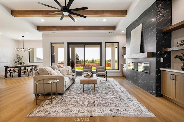 5891 Crestmoor Dr, Paradise, CA 95969 - living room with light wood-style flooring, beamed ceiling, a fireplace, ceiling fan, and recessed lighting