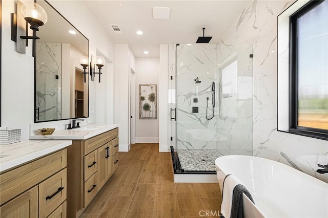 5891 Crestmoor Dr, Paradise, CA 95969 - bathroom with a marble finish shower, a soaking tub, vanity, recessed lighting, and wood finished floors