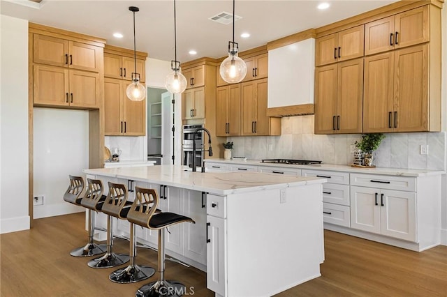 5891 Crestmoor Dr, Paradise, CA 95969 - kitchen featuring wood finished floors, stovetop, backsplash, light stone countertops, and double oven