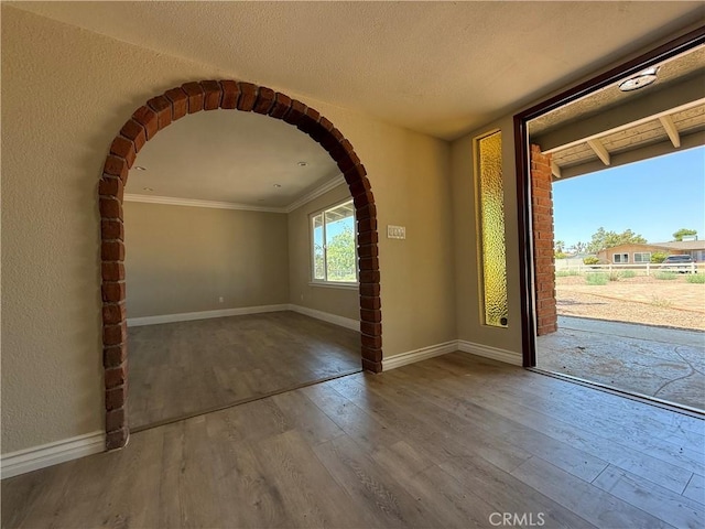 20219 Osseo Rd, Apple Valley, CA 92308 - foyer featuring wood-type flooring, arched walkways, and crown molding