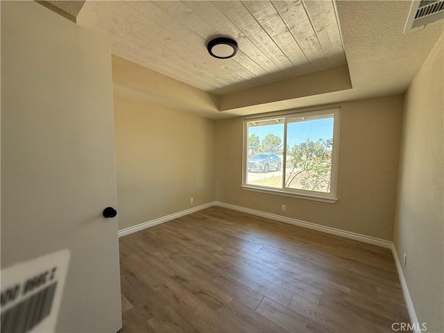 20219 Osseo Rd, Apple Valley, CA 92308 - empty room featuring wood finished floors, wooden ceiling, and a raised ceiling
