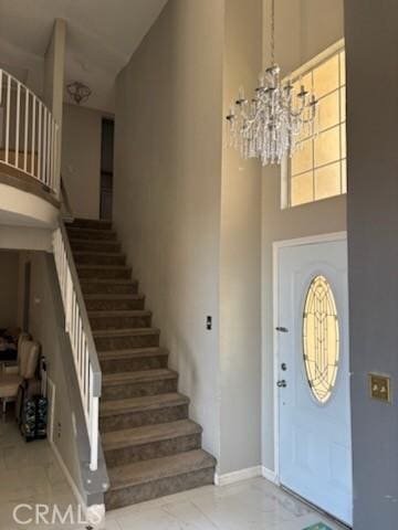 1725 Le Niche Ln, Lancaster, CA 93535 - foyer with a towering ceiling, stairs, a chandelier, and marble finish floors