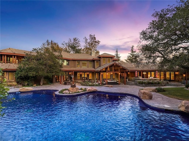 11485 Awenita Ct, Chatsworth, CA 91311 - pool at dusk featuring an outdoor pool and a patio area