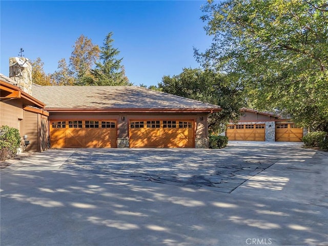 11485 Awenita Ct, Chatsworth, CA 91311 - view of side of home with a garage, a chimney, and driveway