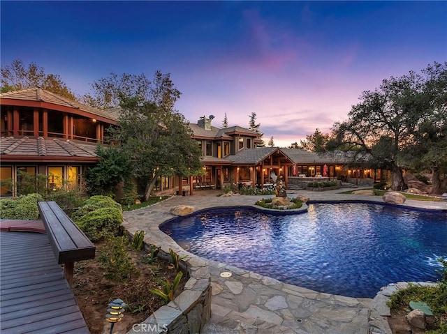 11485 Awenita Ct, Chatsworth, CA 91311 - pool at dusk featuring an outdoor pool and a patio area