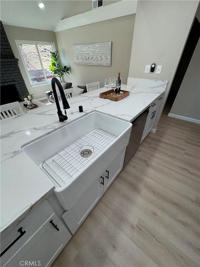 2317 Ravenfall Ave, Rowland Heights, CA 91748 - bathroom with wood finished floors, vaulted ceiling, recessed lighting, and a fireplace