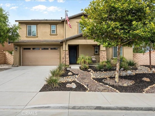 35403 Laurel Tree Ct, Winchester, CA 92596 - traditional-style home with stucco siding, a porch, concrete driveway, a garage, and stone siding