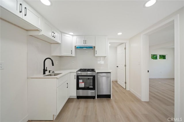 4365 Oneill St, Los Angeles, CA 90032 - kitchen featuring appliances with stainless steel finishes, under cabinet range hood, light wood-style flooring, white cabinetry, and light countertops