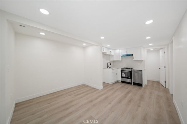 4365 Oneill St, Los Angeles, CA 90032 - kitchen featuring appliances with stainless steel finishes, recessed lighting, light countertops, light wood-style flooring, and white cabinetry