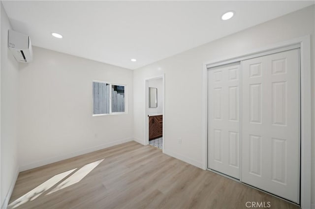 4365 Oneill St, Los Angeles, CA 90032 - unfurnished bedroom featuring a wall unit AC, light wood-style flooring, a closet, ensuite bath, and recessed lighting