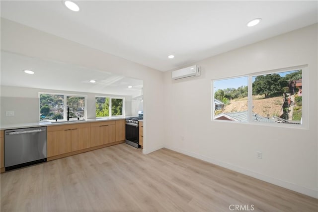 4365 Oneill St, Los Angeles, CA 90032 - kitchen with appliances with stainless steel finishes, a wall mounted air conditioner, light wood-style floors, light countertops, and recessed lighting