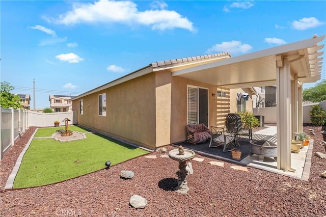 16767 Desert Lily St, Victorville, CA 92394 - view of property exterior with a patio, a fenced backyard, and stucco siding
