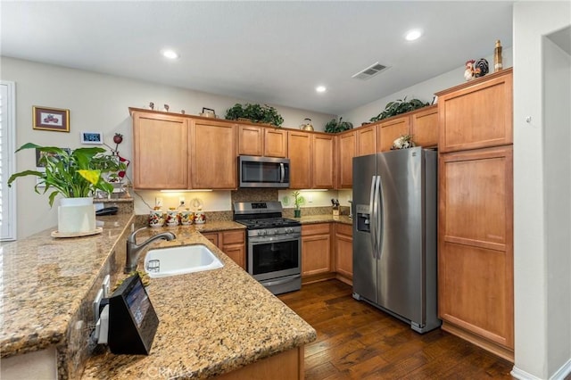 16767 Desert Lily St, Victorville, CA 92394 - kitchen featuring stainless steel appliances, a peninsula, dark wood-style floors, light stone counters, and recessed lighting