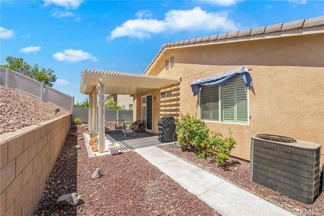 16767 Desert Lily St, Victorville, CA 92394 - rear view of house with stucco siding, a patio, a pergola, and a fenced backyard