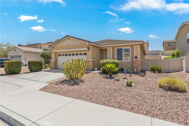 16767 Desert Lily St, Victorville, CA 92394 - ranch-style home with stucco siding, a garage, driveway, a tile roof, and stone siding