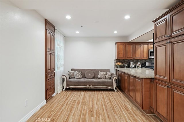 301 W Loraine St Unit 3, Glendale, CA 91202 - kitchen with stainless steel microwave, recessed lighting, light wood-style floors, tasteful backsplash, and stove