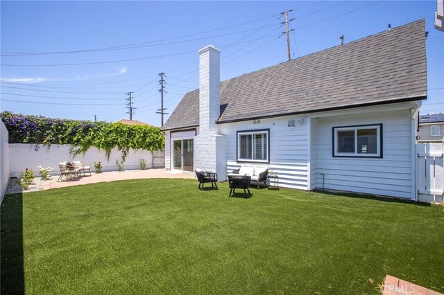 2306 255th St, Lomita, CA 90717 - back of property featuring roof with shingles, a chimney, a fenced backyard, and a patio area