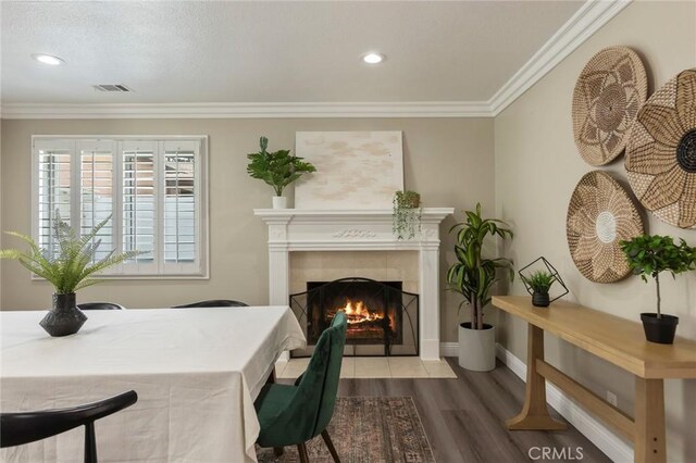 2306 255th St, Lomita, CA 90717 - dining area featuring a tiled fireplace, wood finished floors, ornamental molding, and recessed lighting