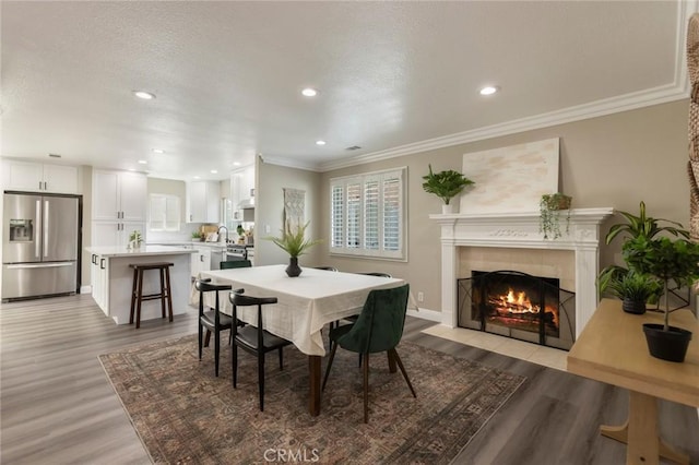 2306 255th St, Lomita, CA 90717 - dining room featuring light wood finished floors, a fireplace, recessed lighting, ornamental molding, and a textured ceiling