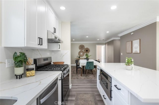 2306 255th St, Lomita, CA 90717 - kitchen featuring appliances with stainless steel finishes, under cabinet range hood, white cabinetry, dark wood-type flooring, and recessed lighting