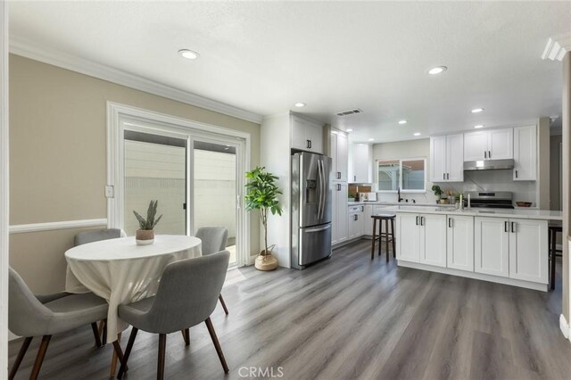 2306 255th St, Lomita, CA 90717 - dining space featuring ornamental molding, wood finished floors, and recessed lighting