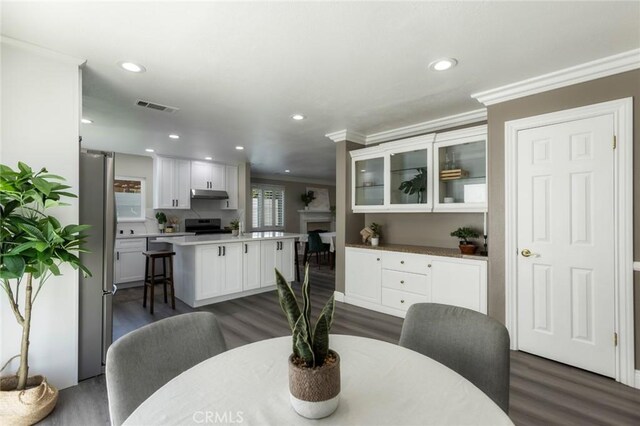 2306 255th St, Lomita, CA 90717 - dining area with crown molding, dark wood-style flooring, recessed lighting, and a fireplace