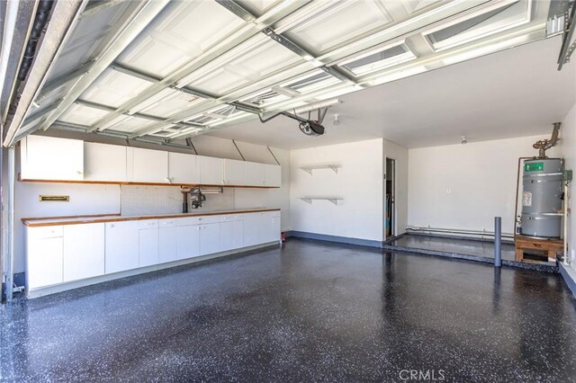2306 255th St, Lomita, CA 90717 - garage featuring strapped water heater, a garage door opener, and a baseboard radiator