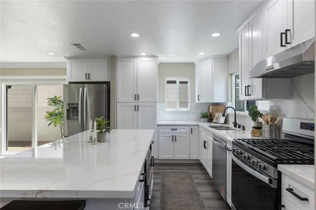 2306 255th St, Lomita, CA 90717 - kitchen with stainless steel appliances, ventilation hood, a kitchen island, light stone counters, and recessed lighting