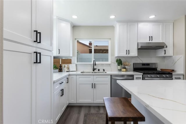 2306 255th St, Lomita, CA 90717 - kitchen with stainless steel appliances, under cabinet range hood, white cabinets, dark wood-style flooring, and recessed lighting